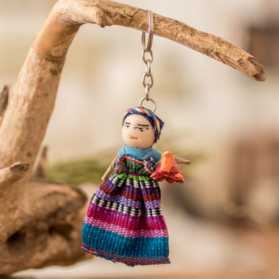 Cotton Keychain of a Worry Doll Holding a Ceramic Turtle