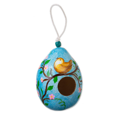 Blue Dried Gourd Birdhouse with Bird on a Flowering Tree
